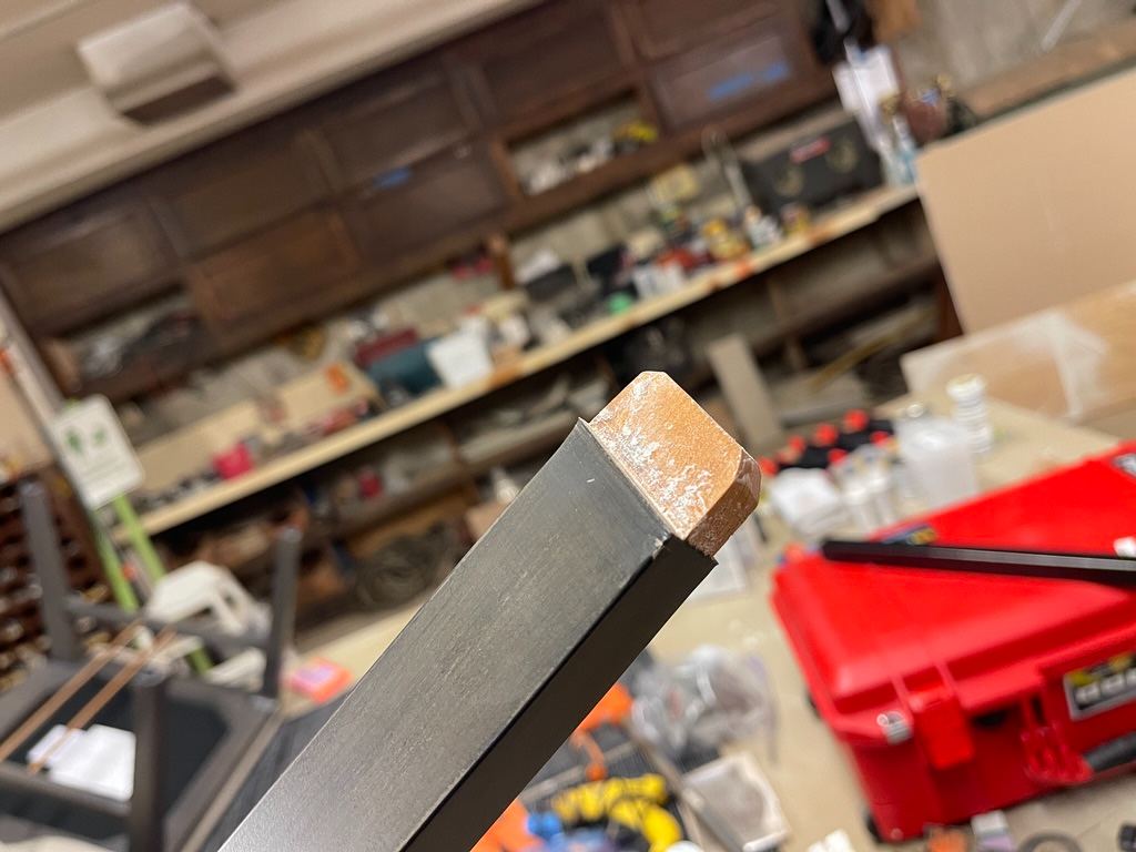 A steel leg end fitted with a wood plug